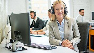 Woman with headset sitting at office desk
