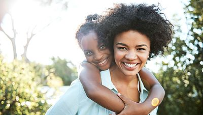 International mother and daughter hugging