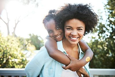 International mother and daughter hugging