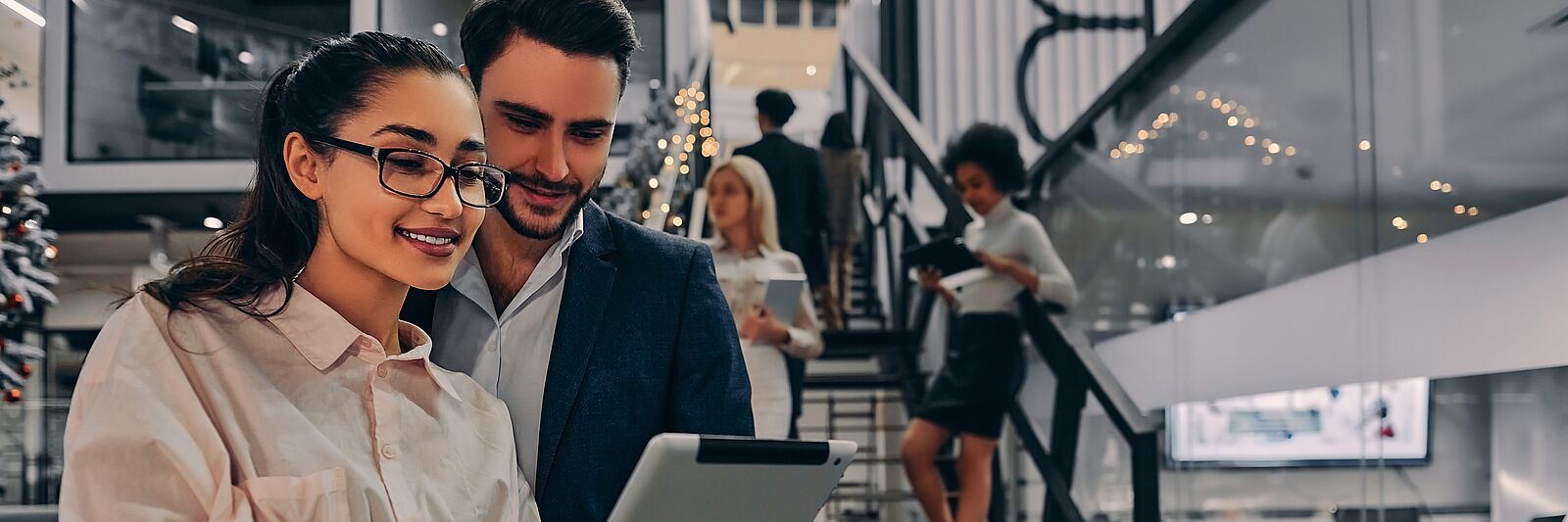 Man and woman in the office looking at the tablet