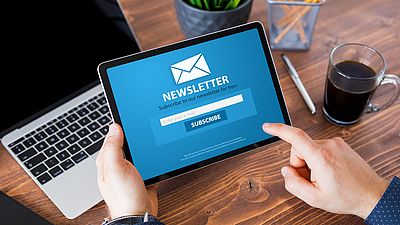 A man subscribing to a newsletter on a tablet