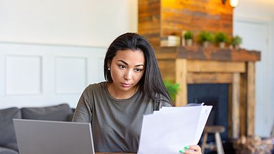 A woman working on her university degree evaluation documents