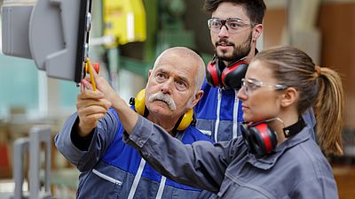 Group of international people working in workshop