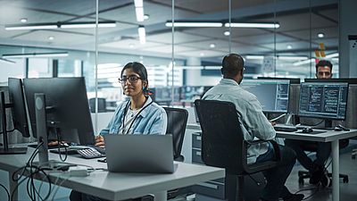 International female IT programmer at work in Germany