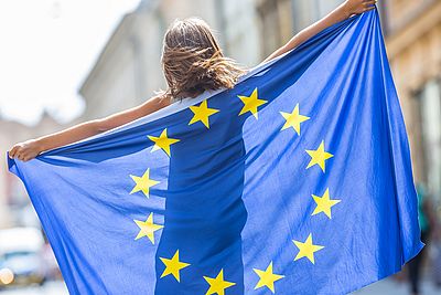 Young woman holding an EU flag