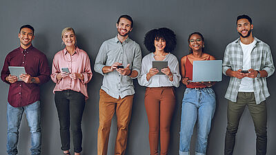 International group of young people with electronic devices is looking for job advertisements