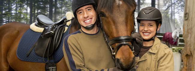 A man and woman stand next to a horse