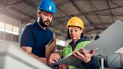 Two international engineers working in a factory