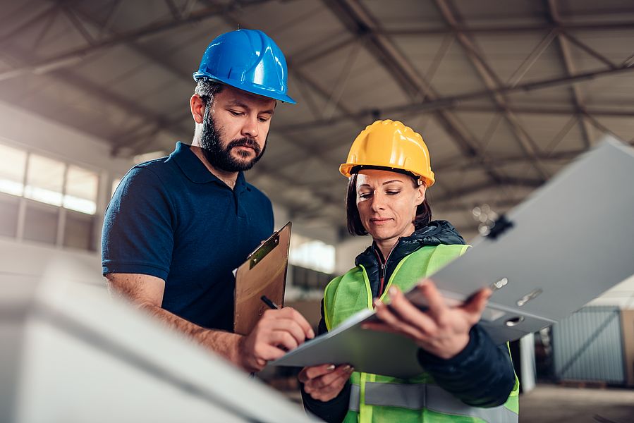 Two international engineers working in a factory