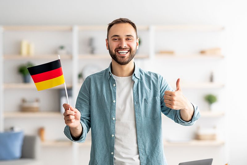 International smiling man with a German flag