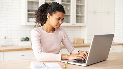 International woman using a laptop to search for information on the internet