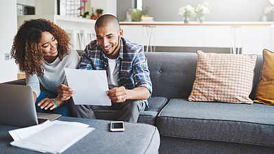 Two people from abroad filling out a visa form