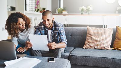 Two people from abroad filling out a visa form