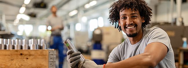 Young man with curls in a warehouse