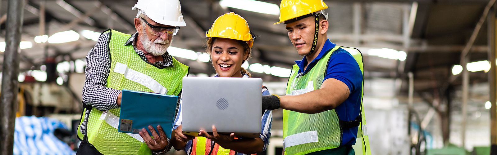 International professionals at work in a factory hall