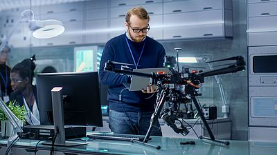 Young researcher programs a drone