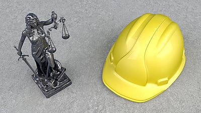 Statue of Lady Justice next to a construction helmet