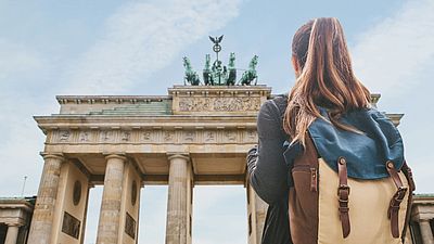International female student with backpack in Berlin