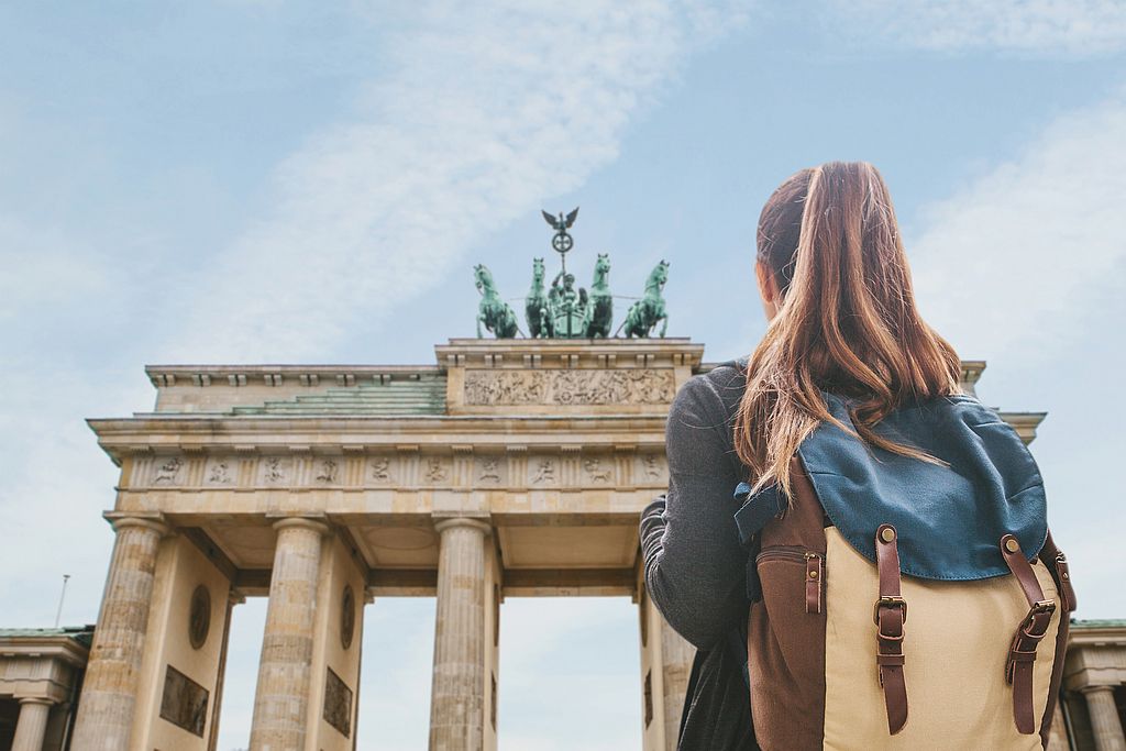 International female student with backpack in Berlin