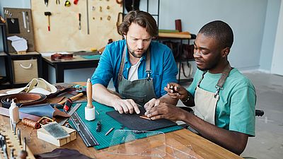 Two international men working in a workshop