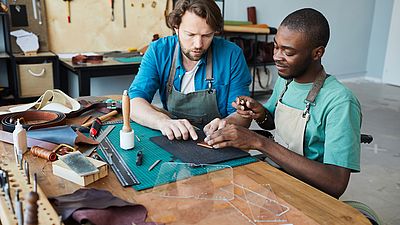 Two international men working in a workshop